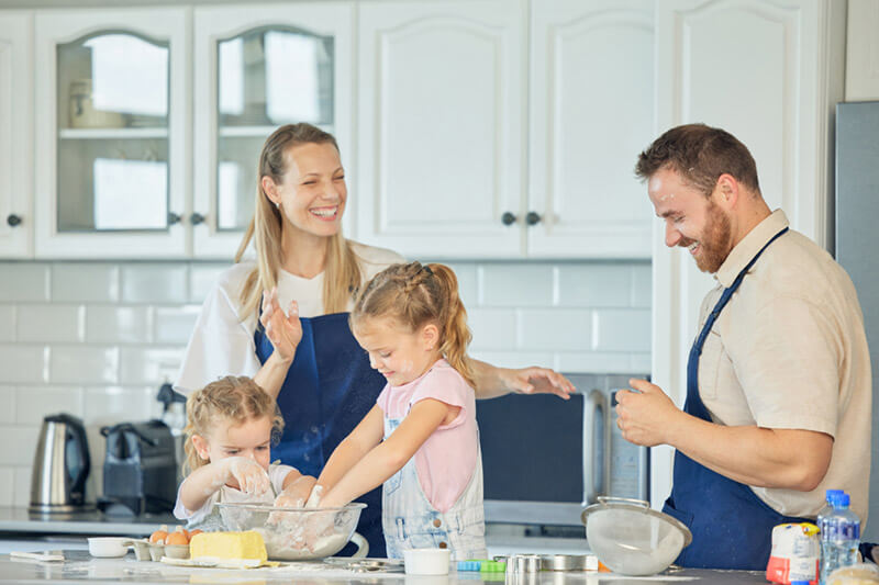 Happy Family Making Food in the Kitchen Together