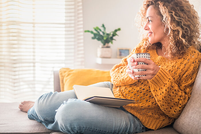 Woman Relaxing on a Couch With a Coffee